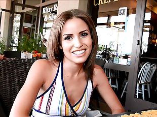 Beautiful Natasha talks on camera in a restaurant