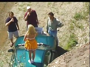 Admirable cheerleader in a gangbang being drilled on a car outdoor