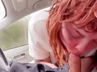 Red-haired girlfriend gives blowjob in the car