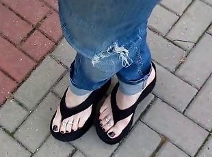 Crossdresser tempts with his feet on the street