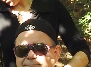 A mature German domina spanks her man in the woods