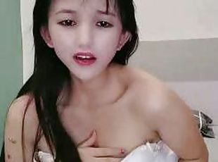 The thirsty young woman looks petite, cute and seductive. She is slutty in front of the camera holding a mineral water bottle and poking it into th...