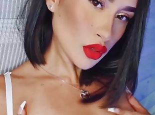 Close up video of a solo brunette with red lipstick having fun