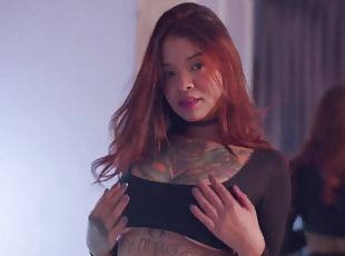 Tattooed redhead wearing lingerie fingering her love tube
