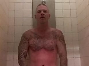 Prisoner takes a shower after getting a haircut