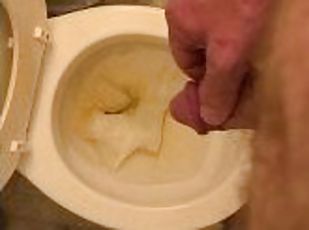 Pissing playing with dick