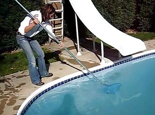 Cute black-haired babe rescuing a frog out of the pool