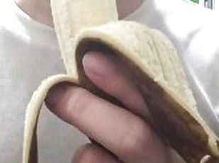 Peel and eat a large, black banana by hand.