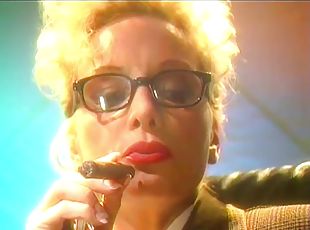 Blonde mature lady with glasses smokes a cigar and plays with her tits