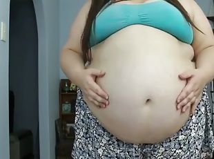 Obese woman puffs up and plays with her gigantic belly